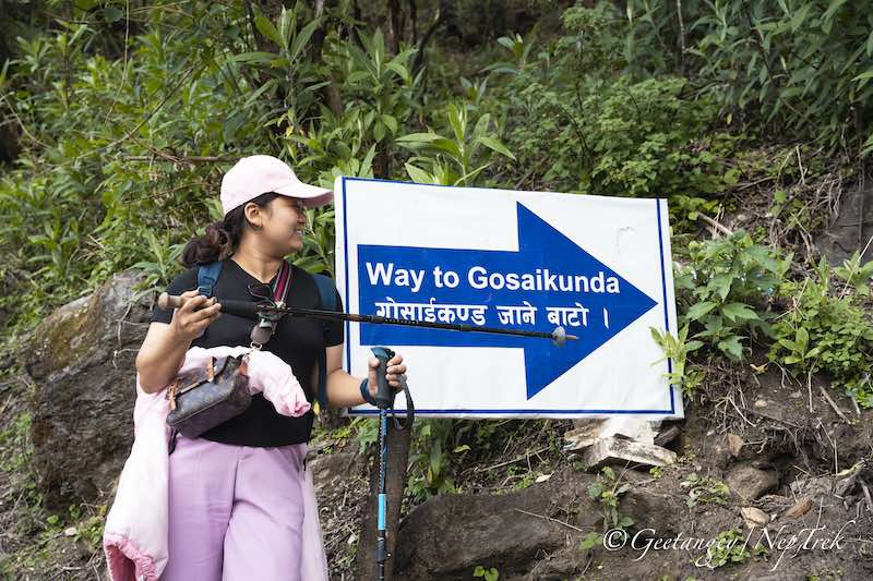 Trekker on Gosaikunda Lake Trek showing the navigation board near Dhunche