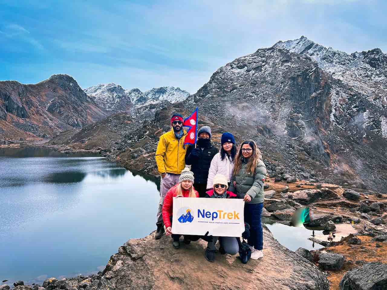 Trekkers on Gosaikunda Trek with NepTrek, posing for a photograph at lakeside viewpoint