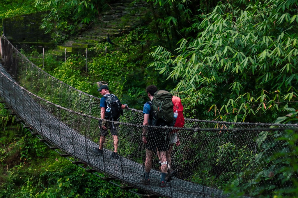 Crossing a suspension bridge at Chipledhunga